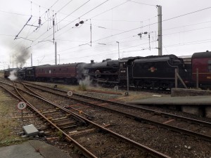 45690 lead by 37706 & 44871 leaving carnforth station july 2018